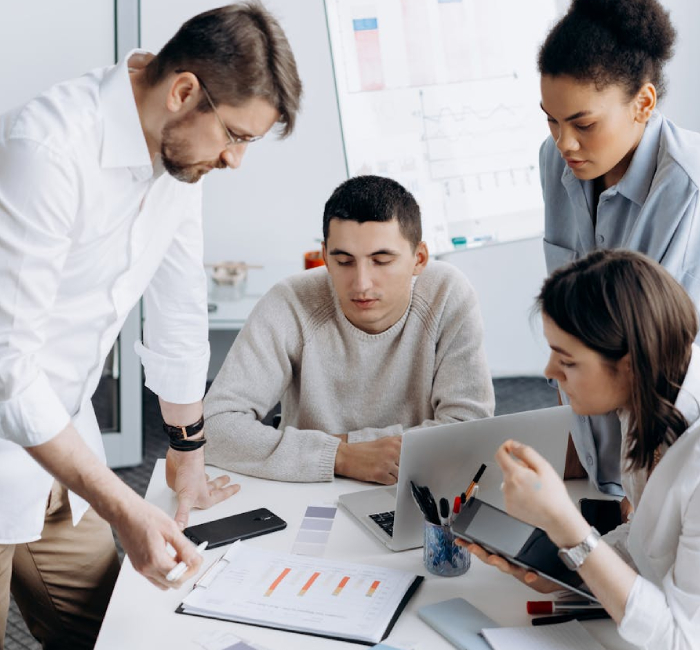 A team of NDIS Provider specialists reviewing reports at a desk