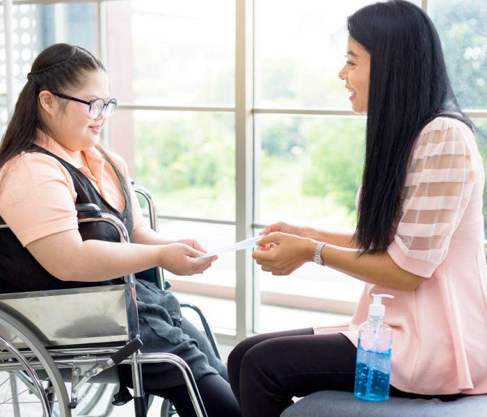 A woman helps a student for NDIS Support for Daily Activities